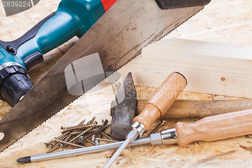 Image of Drill with timber, screwdrivers and screws