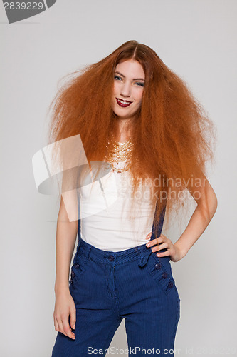 Image of Female model playing with frizzy hair