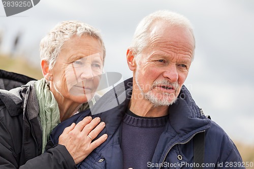 Image of happy elderly senior couple walking on beach