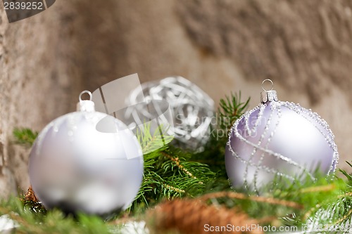 Image of Silver Christmas ornaments in leaves