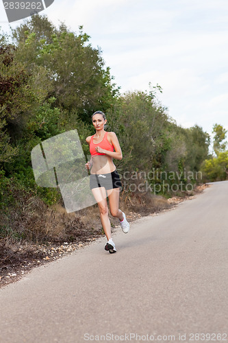 Image of Fit young woman jogging