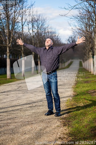 Image of Middle-aged man enjoying the sunshine