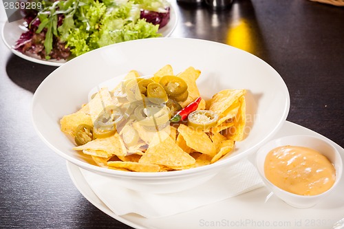 Image of Nachos with cheese sauce and chilli pepperoni