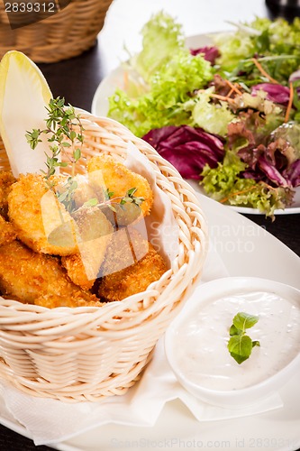 Image of Crumbed chicken nuggets in a basket