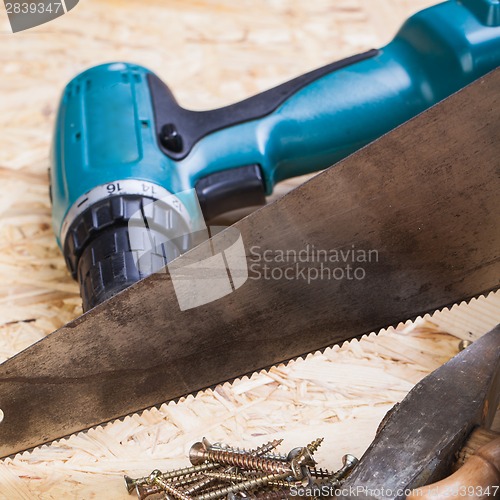 Image of Drill with timber, screwdrivers and screws