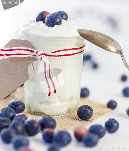 Image of Jar of clotted cream or yogurt with blueberries