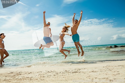 Image of young happy friends havin fun on the beach