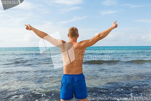 Image of Man in blue swim shorts in the beach