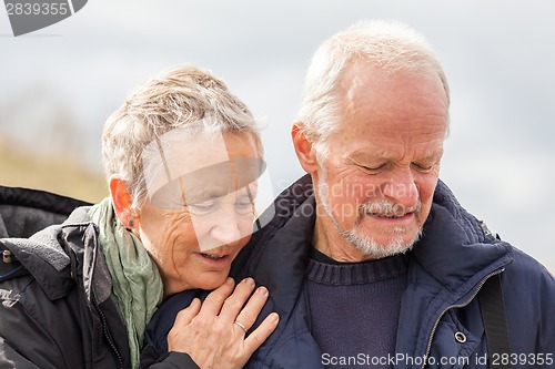 Image of happy elderly senior couple walking on beach