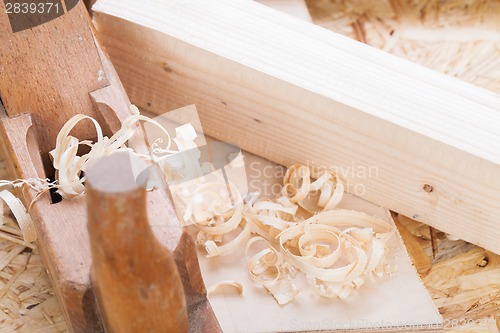 Image of Handheld wood plane with wood shavings