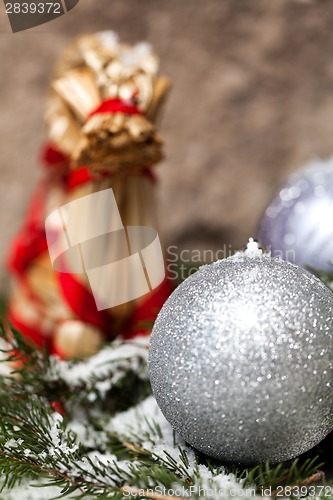 Image of Silver Christmas bauble on a tree with snow