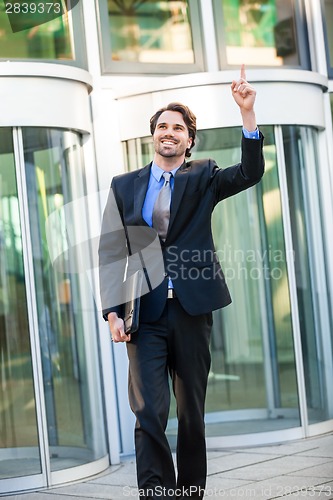 Image of Motivated businessman punching the air