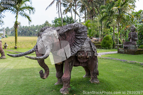 Image of Elephant statue standing on a lawn at a park