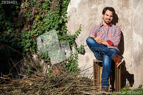 Image of Male model sitting with legs crossed