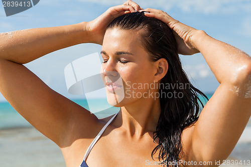 Image of Young woman looking far away in the beach