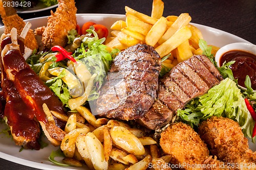 Image of Platter of mixed meats, salad and French fries