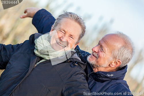 Image of Elderly couple embracing and celebrating the sun