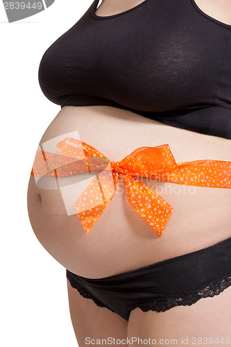 Image of Pregnant woman wearing a bow on her belly