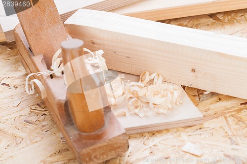 Image of Handheld wood plane with wood shavings