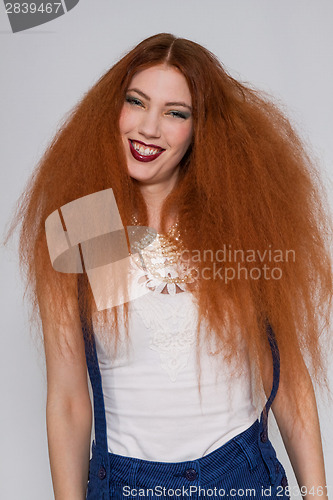 Image of Female model playing with frizzy hair