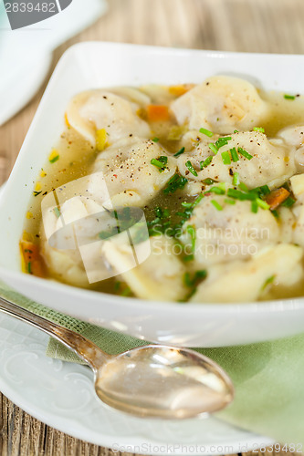 Image of Dish of savory pork tortellini in broth pelmeni russian