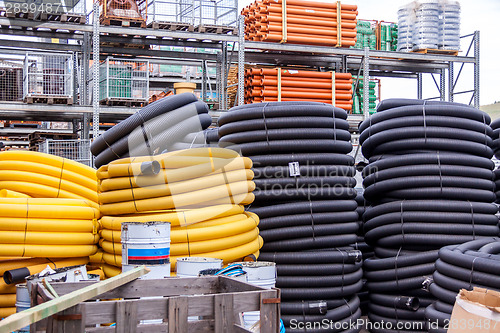 Image of Rolls of plastic pipes in a warehouse yard