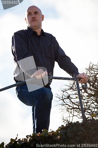 Image of Thoughtful man sitting on a flight of steps