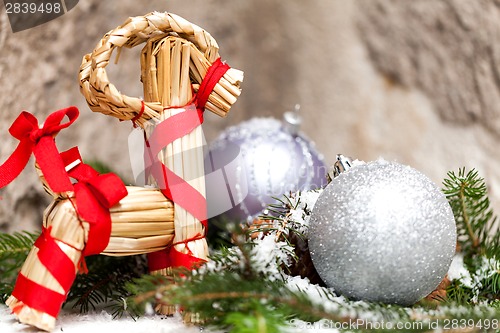 Image of Silver Christmas bauble on a tree with snow