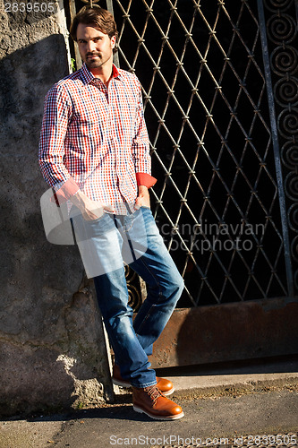 Image of Male model leaning against wall