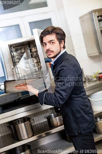 Image of Chef cooking a vegetables stir fry over a hob