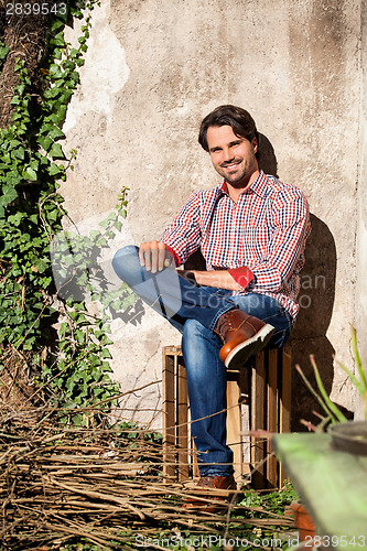 Image of Male model sitting with legs crossed