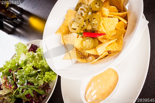 Image of Nachos with cheese sauce and chilli pepperoni