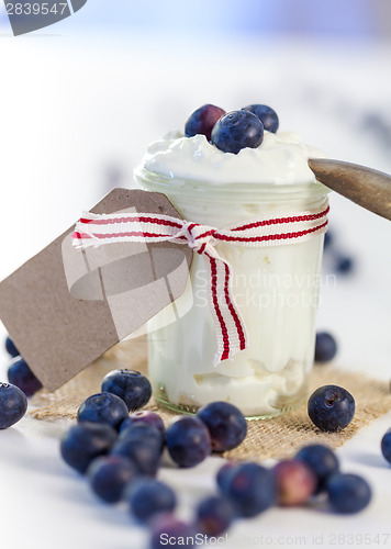 Image of Jar of clotted cream or yogurt with blueberries