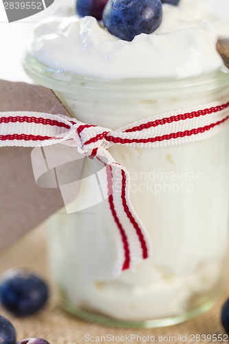 Image of Jar of clotted cream or yogurt with blueberries