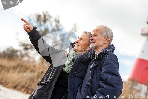 Image of happy mature couple relaxing baltic sea dunes 