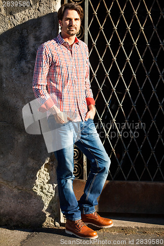 Image of Male model leaning against wall