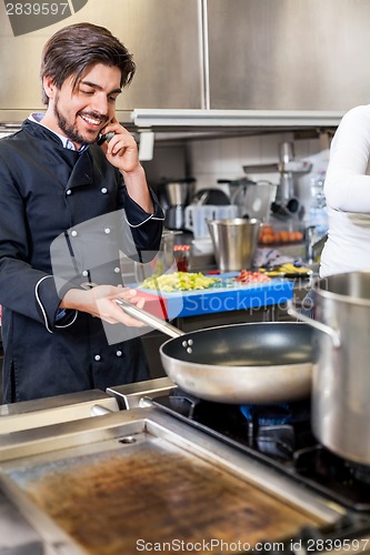 Image of Chef taking a call on his smartphone