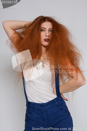 Image of Female model playing with frizzy hair