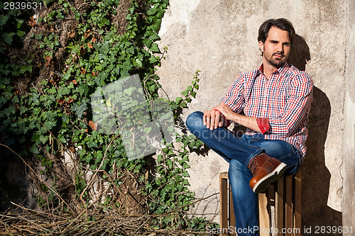 Image of Male model sitting with legs crossed