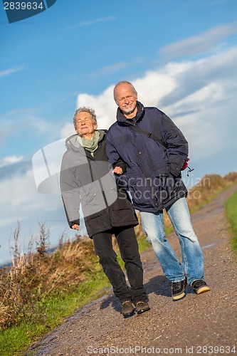 Image of happy mature couple relaxing baltic sea dunes 