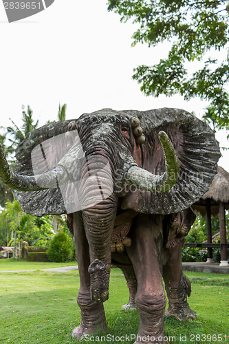 Image of Elephant statue standing on a lawn at a park