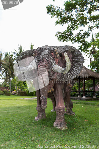 Image of Elephant statue standing on a lawn at a park