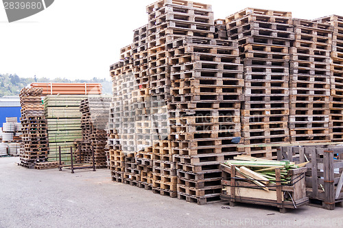 Image of Stacks of old wooden pallets in a yard