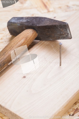 Image of Mallet with nails and planks of new wood