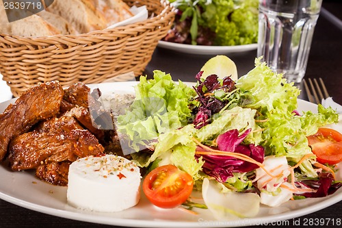 Image of grilled beef stripes fresh salad and goat cheese