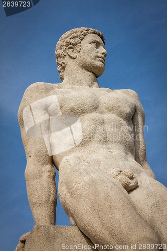 Image of Bird perched on an ancient stone statue