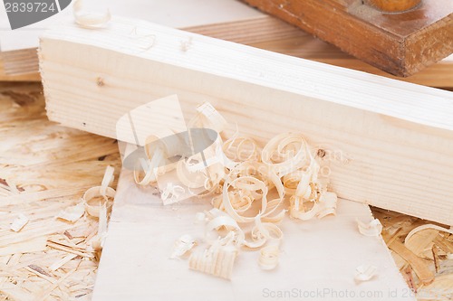 Image of Handheld wood plane with wood shavings