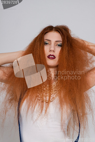 Image of Female model playing with frizzy hair