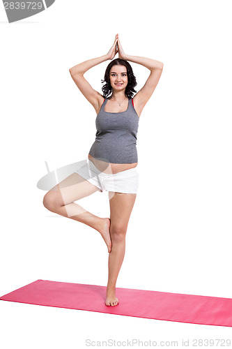 Image of Active young pregnant woman doing yoga