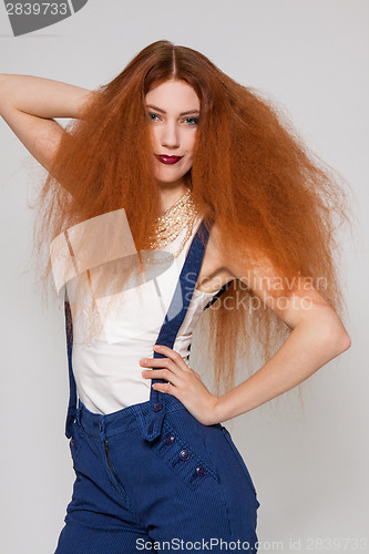 Image of Female model playing with frizzy hair